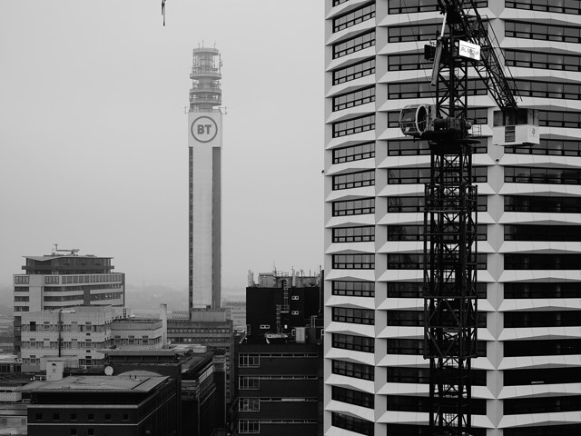 September 2026 Cityscape with tall buildings and construction crane (Unsplash/@mikehindle/6CvoFRLGU4M)