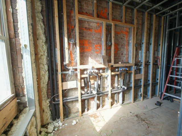 October 2026 Interior construction with exposed pipes and framing (Unsplash/@olek_bznv_photo/ONBOCKM9Fo)